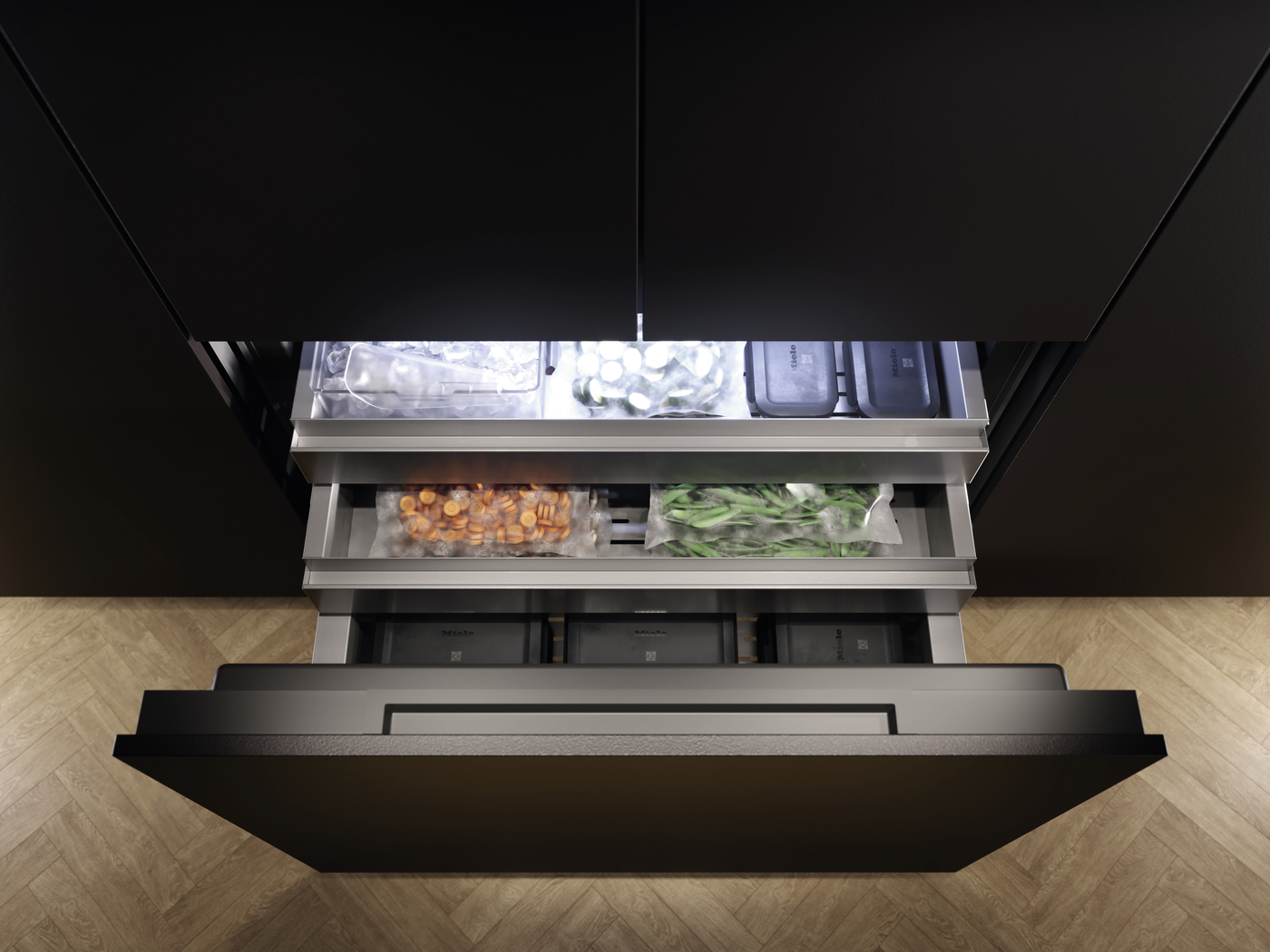 Top-down view of a sleek black refrigerator with open drawers; frozen vegetables in bags and ice in the upper compartments visible in a modern kitchen.