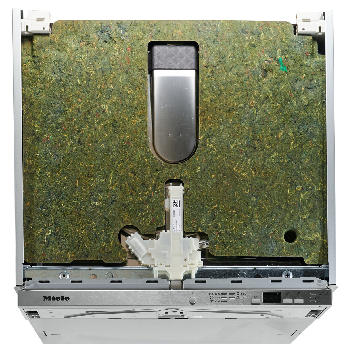 Open Miele dishwasher with the inner green insulation panel and metal frame visible inside the door area. The bottom control console with the Miele logo is also visible in the foreground.