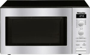 Stainless steel microwave with black door and right-side control panel showing 12:45.