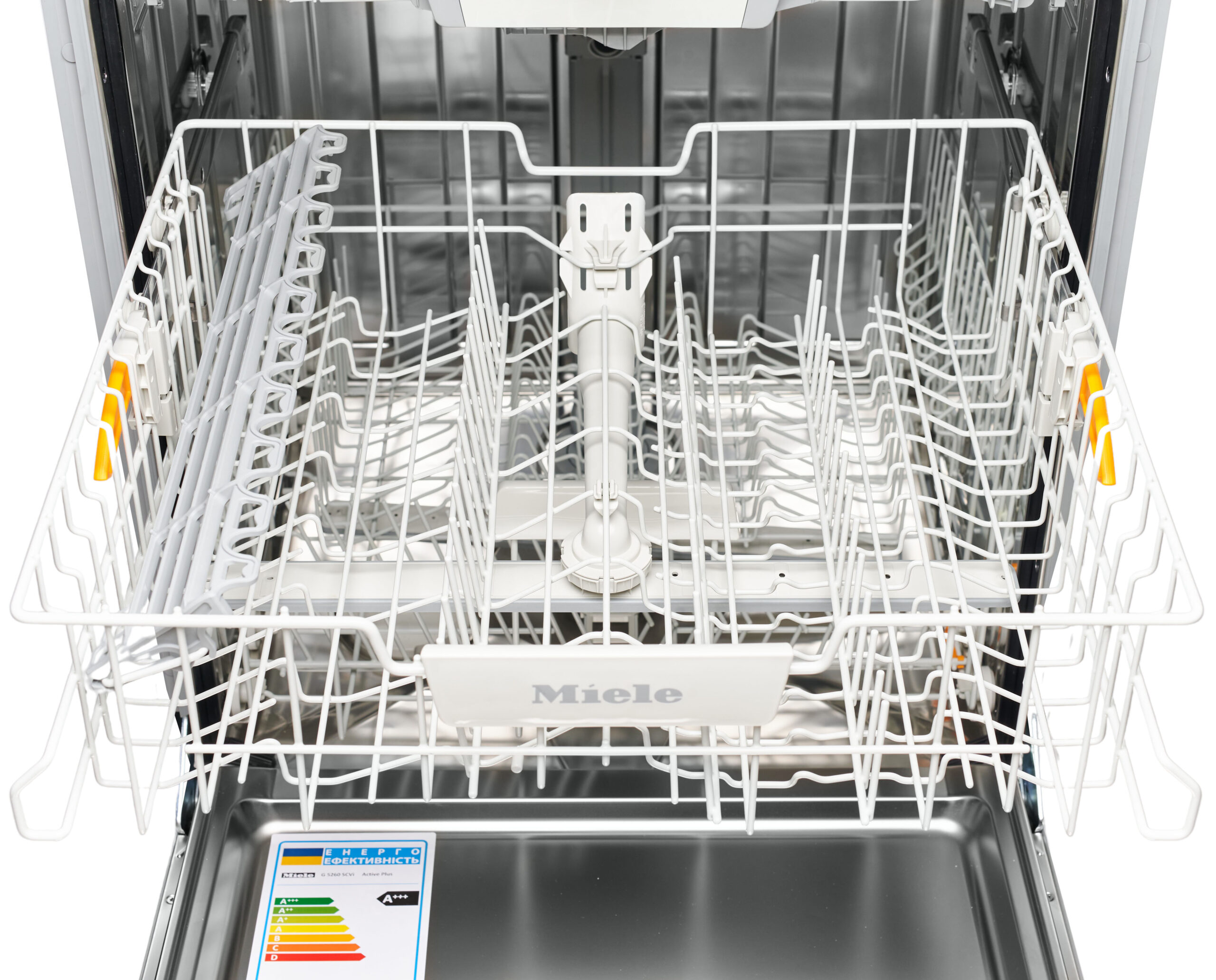 Open Miele dishwasher with racks pulled out, interior clean and empty, spray arm visible in center.
