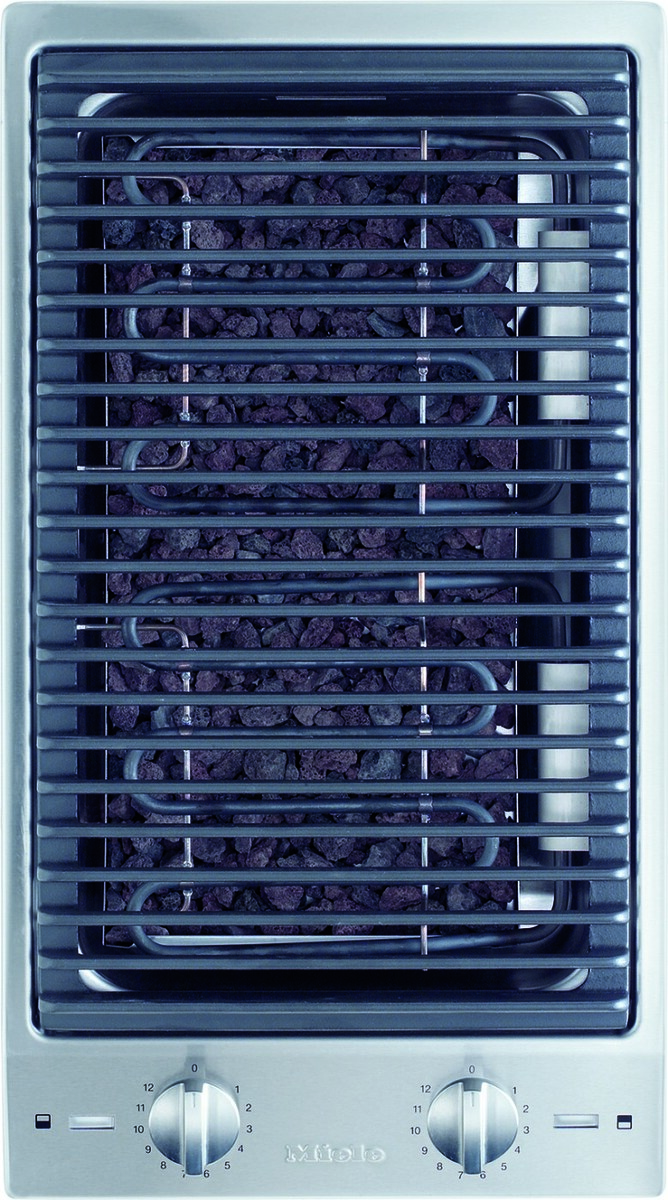Electric grill/oven with a metal rack over a bed of dark lava rocks and control dials beneath