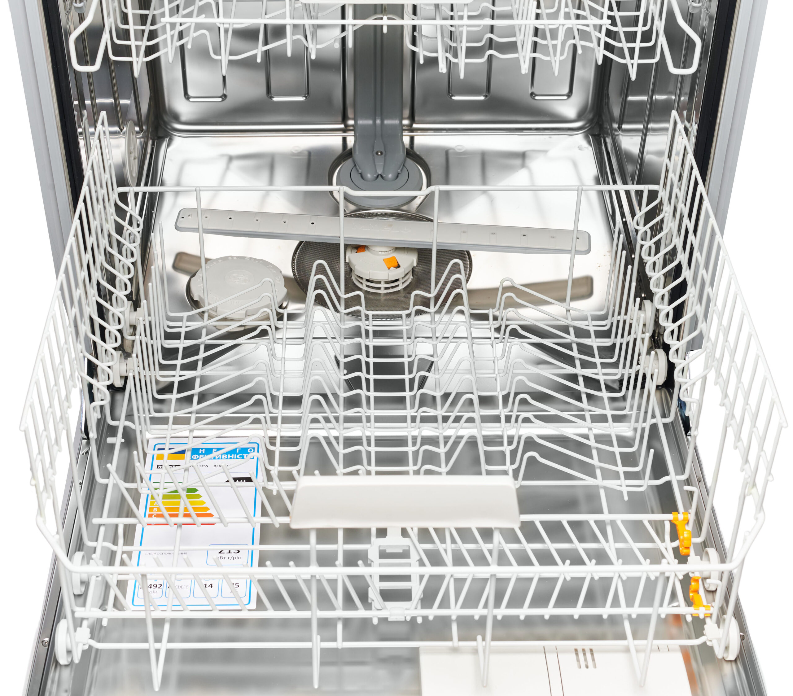 Open dishwasher interior with metal racks and spray arms, empty bottom and middle shelves visible, stainless steel walls.