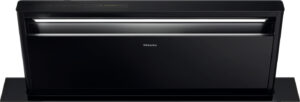 Front view of a black Miele built-in dishwasher with the control panel on top.