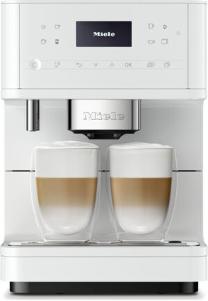 White Miele espresso machine with two glass cups of layered lattes on the drip tray, ready to brew