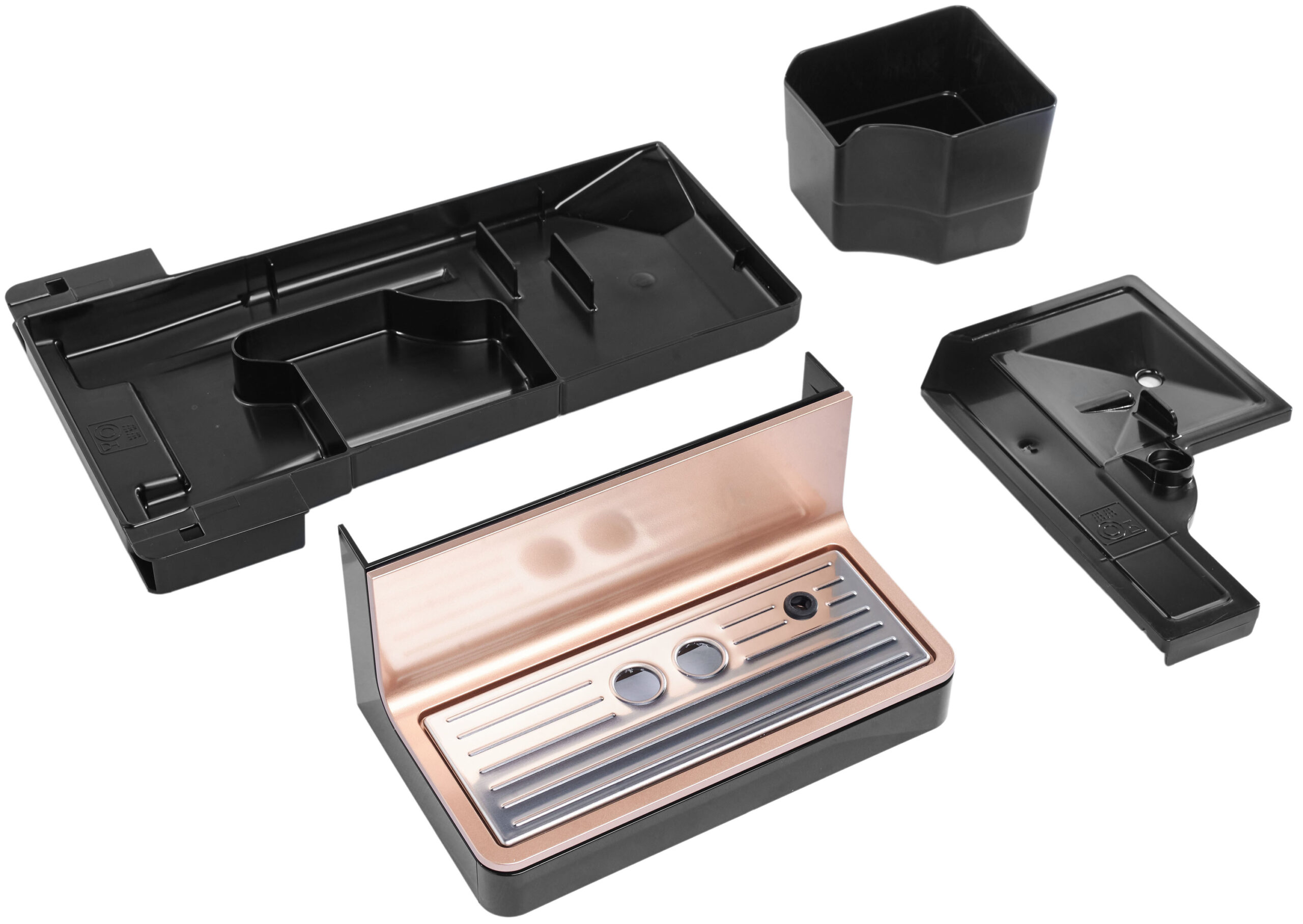 Assorted empty makeup storage cases in black and rose gold, opened to reveal compartments and trays.