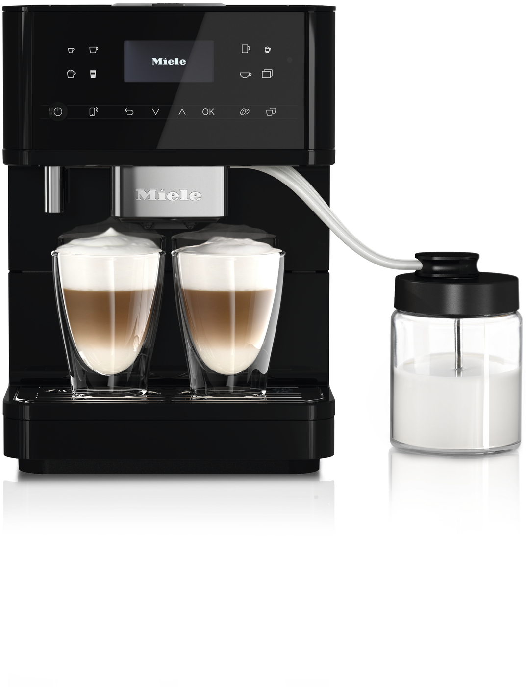Miele espresso machine with two glass cups of cappuccino and a connected milk jug on the side
