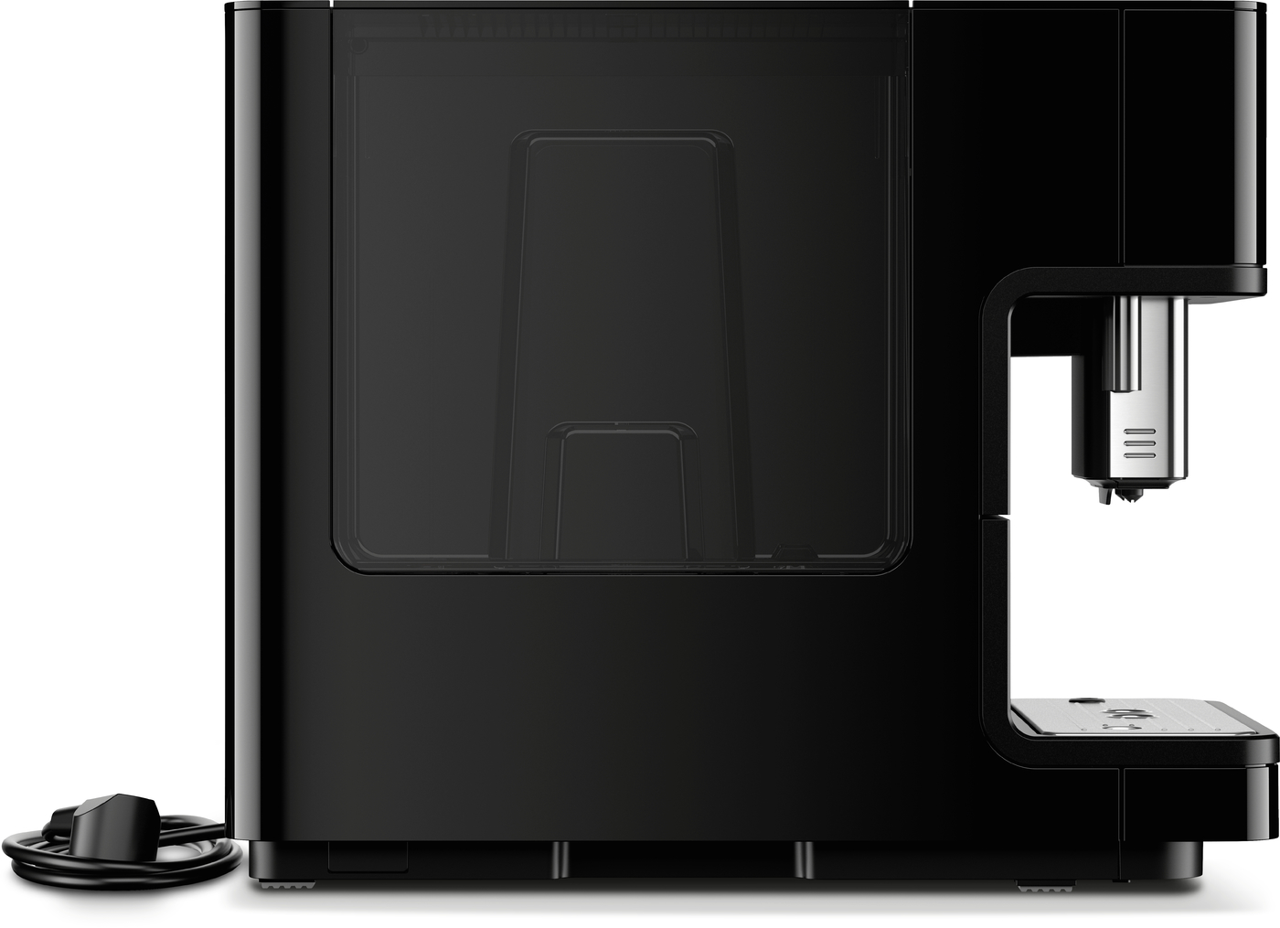 Black espresso machine with side view, built-in water reservoir, and drip tray; power cord coiled nearby at left.