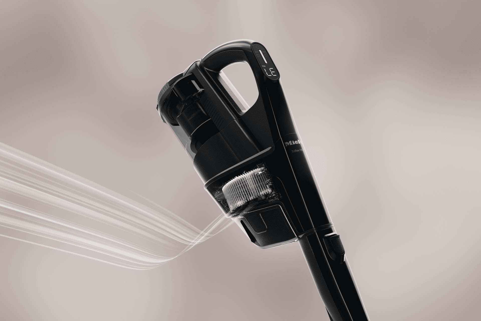 Close-up of a black Miele cordless vacuum cleaner head angled upward, showing a digital display on the handle.