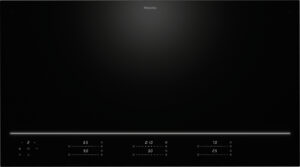 Miele black glass cooktop with a glowing white control bar along the bottom edge and touch controls beneath it.