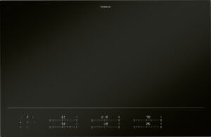 Sleek black Miele induction cooktop with a minimalist control strip along the bottom edge and subtle illuminated numbers.