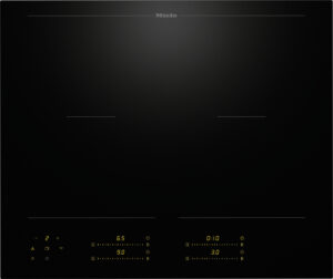 Miele induction cooktop with two cooking zones and yellow control readouts at the bottom of the glass surface