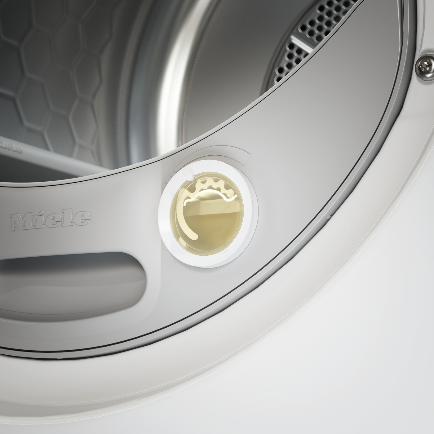 Close-up of a Miele front-loading washing machine door lock with a gold-colored latch visible in the circular opening.