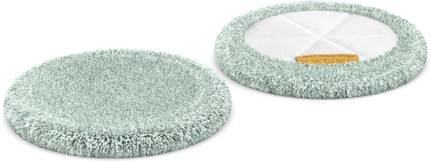 Two round mint-green microfiber cleaning pads for a mop, shown side by side, one with a white backing and orange label edge.