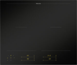 Miele black glass induction cooktop with four touch controls and yellow digital readouts at bottom façade.